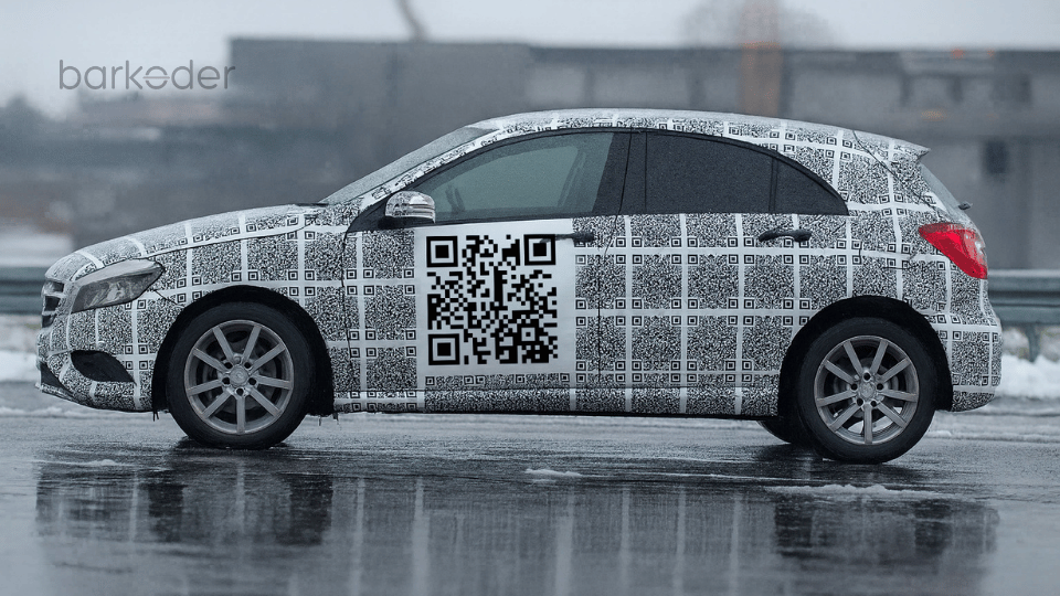 A car covered in QR code decals, representing intelligent mobility scanning.