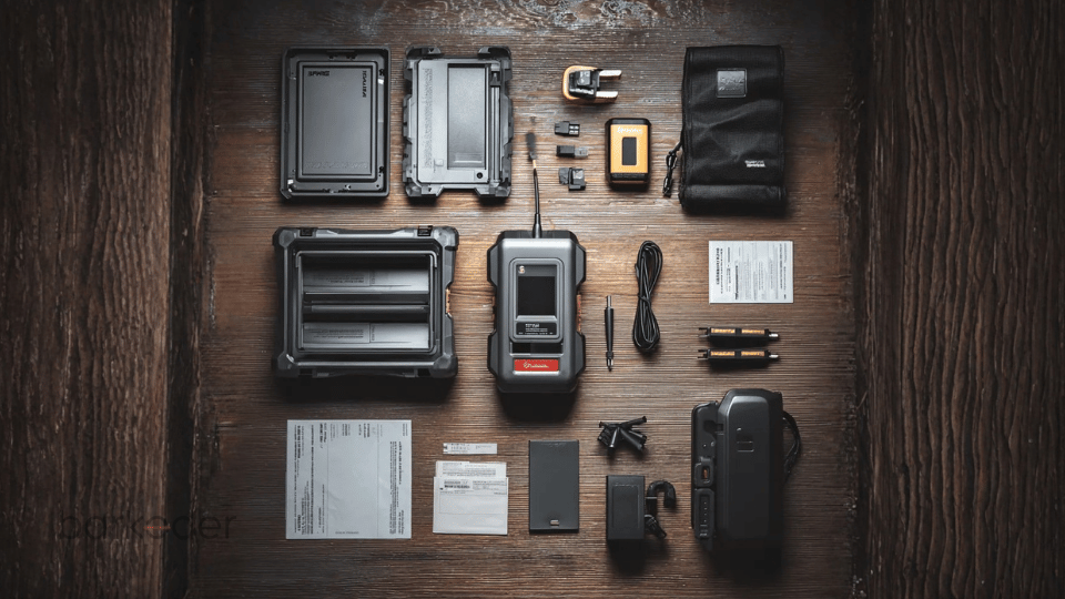 Industrial scanner kit with multiple accessories arranged neatly on a wooden surface.